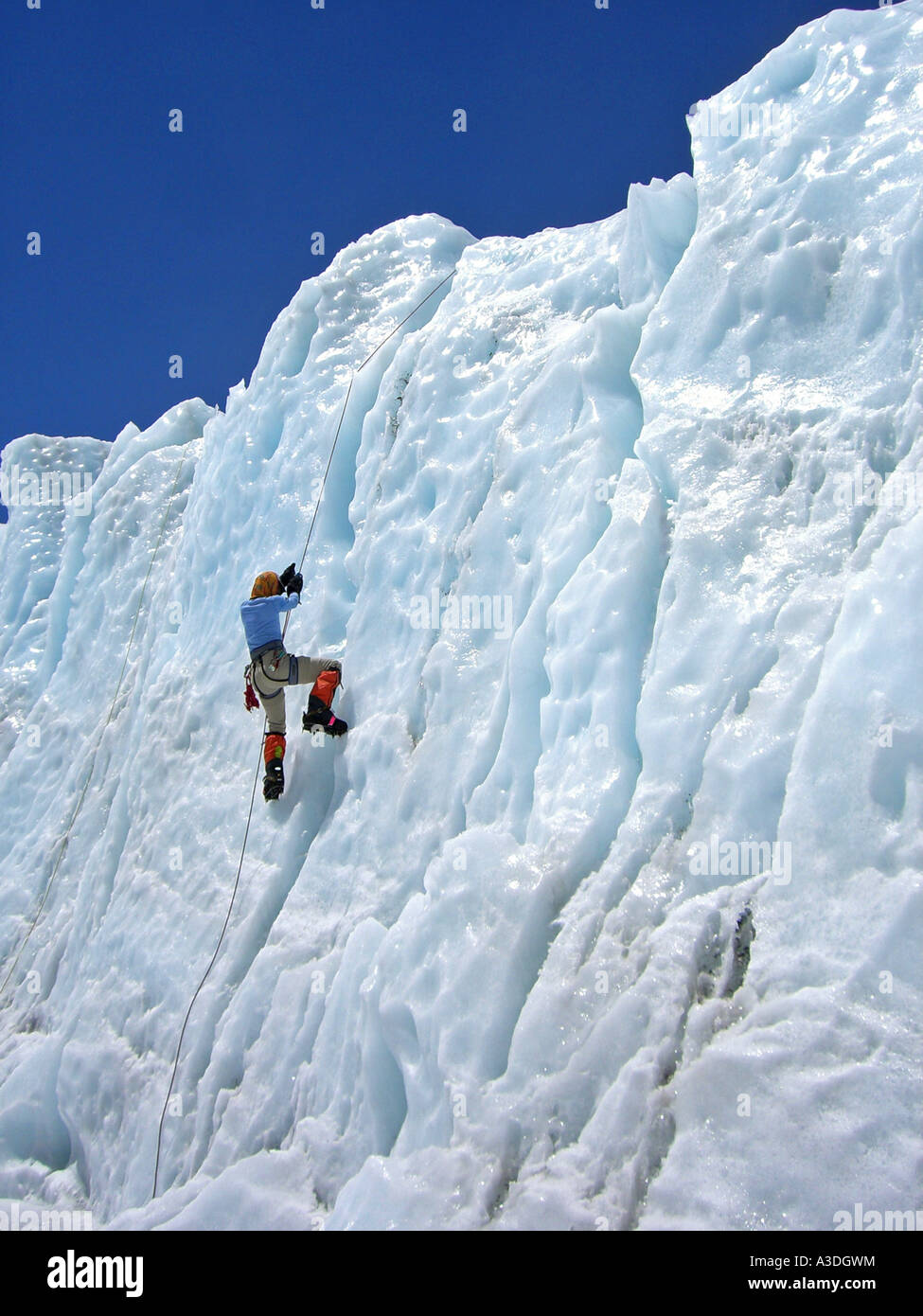 Female climber with crampons on a rope in lower Khumbu Icefall, Base