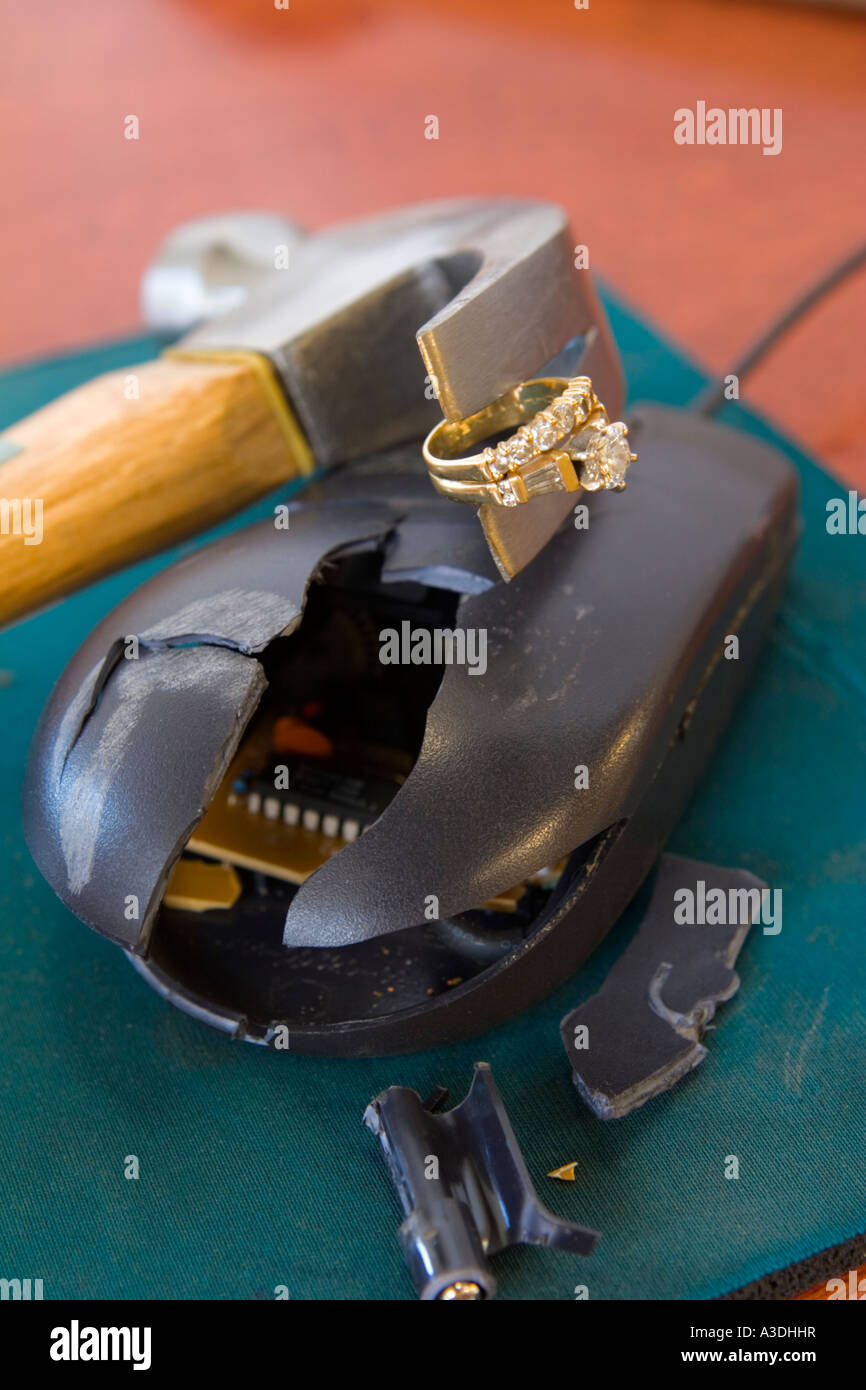 Malfunctioning computer mouse meets destiny. Is glittering diamond ring compensation or casuality? Stock Photo