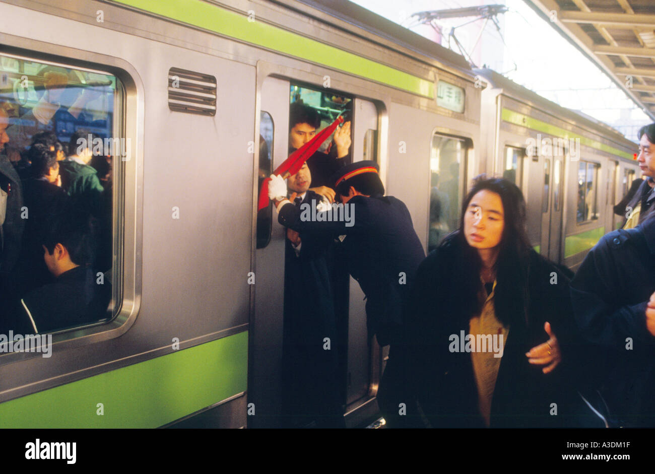 MAN WITH MEGAPHONE PUSH COMMUTERS INTO CROWDED TRAIN SO DOORS WILL CLOSE  RUSH HOUR AT PEOPLE S SQUARE SHANGHAI CHINA Stock Photo - Alamy