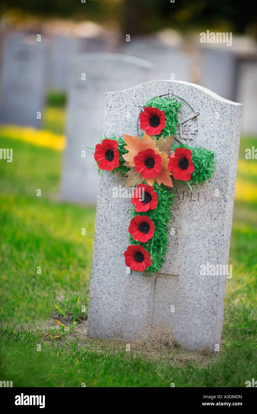 Grave stone with poppy wreath Stock Photo
