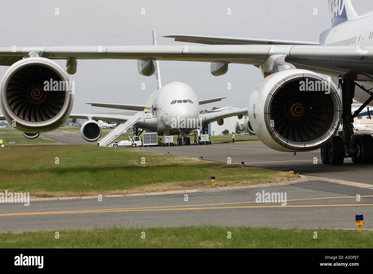 Airbus A380 framed by wing and engines of Airbus A340 Stock Photo