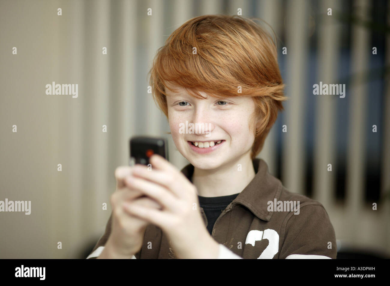 Boy Is Playing A Game On A Mobile Phone Stock Photo Alamy