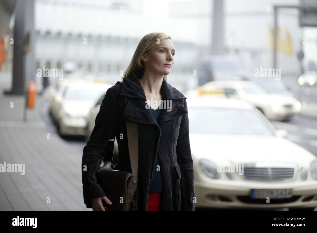 Young woman looking for a taxi Stock Photo