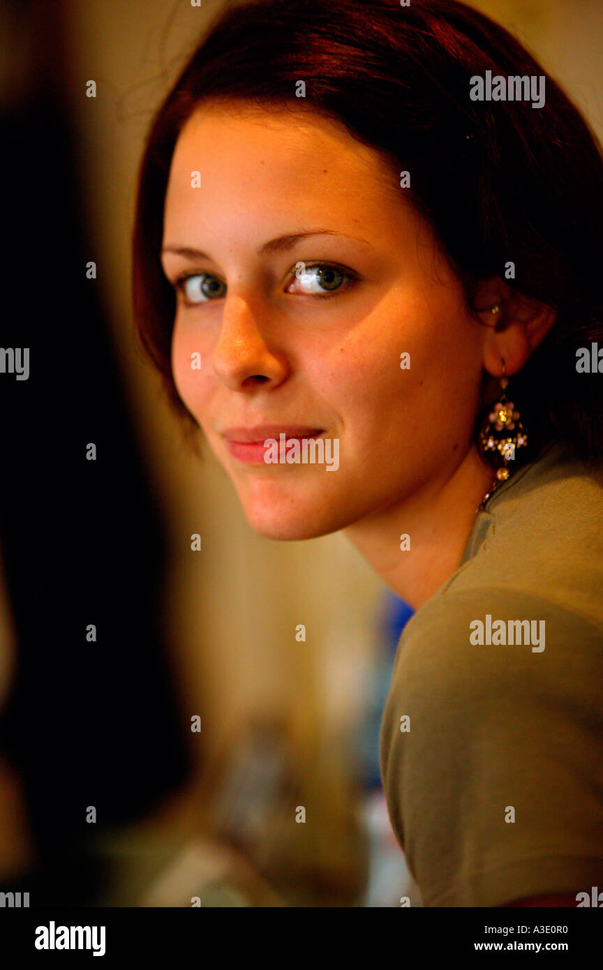 Face of beautiful young woman looking at camera with enigmatic smile Stock Photo