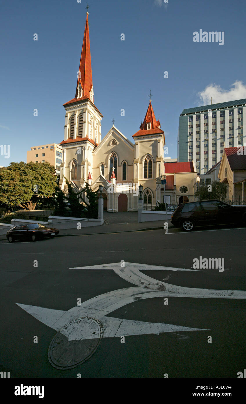 New Zealand, Wellington. St John's Presbyterian Church, with diverging arrows painted on road in  foreground Stock Photo