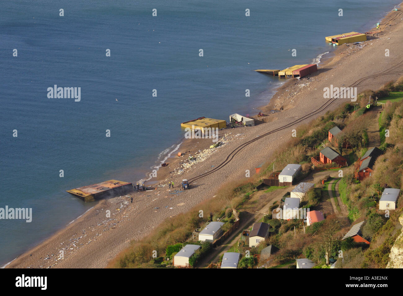 Pollution on Branscombe Beach DevonUK  among beach huts of wrecked shipping containers from the MSC Napoli ship January 2007 UK Stock Photo