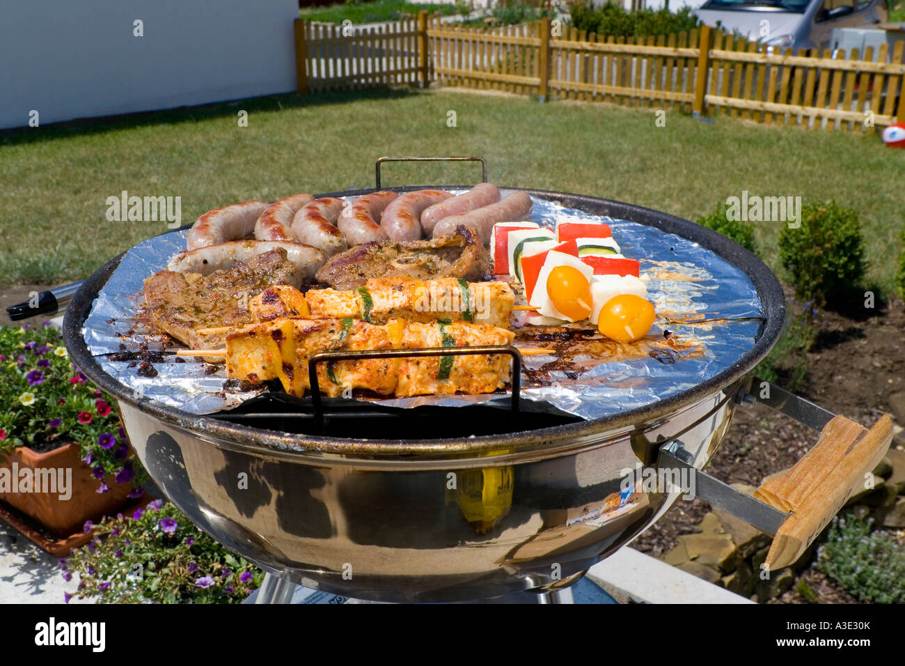 A barbecue with meat and sausages on it Stock Photo
