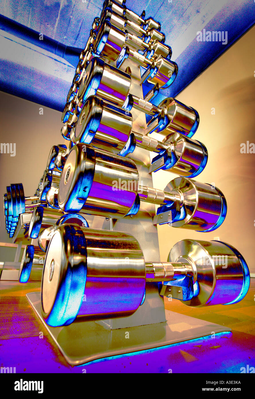 Hand-weights on a rack in a gym - false colour Stock Photo - Alamy