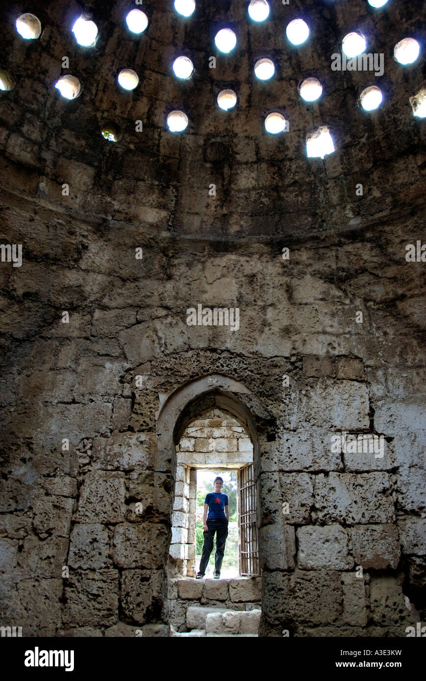 Young woman stands in the entrance of the old Hamam in the old town of Famagusta Gazimagusa North Cyprus Stock Photo