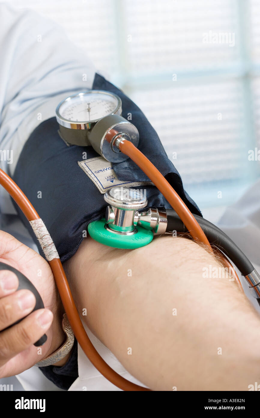 Blood Pressure monitor  Sphygmometer on patient's arm. Stock Photo