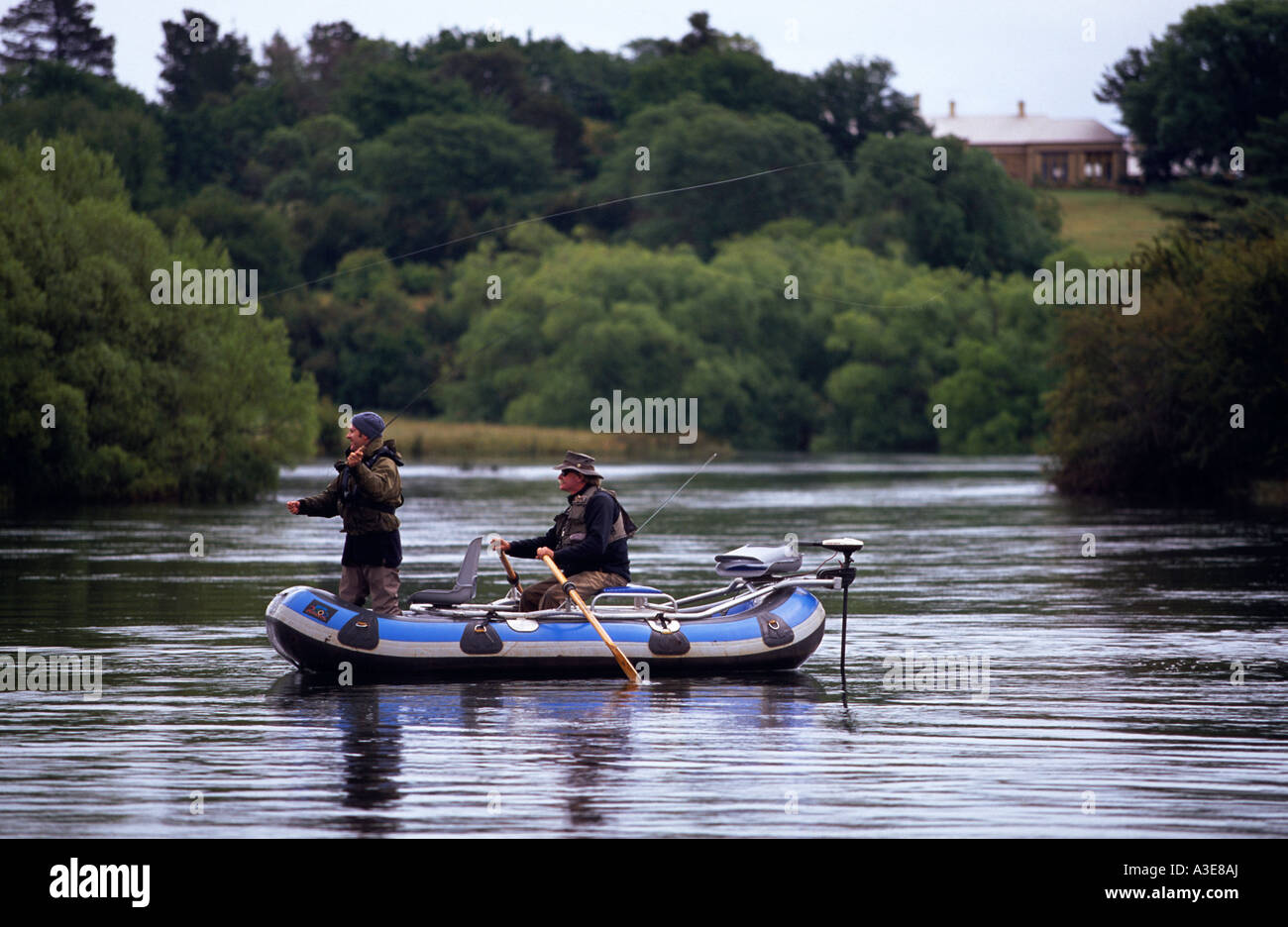 Fly fishing from float tube Macquarie River near Cressy North East Tasmania Australia horizontal