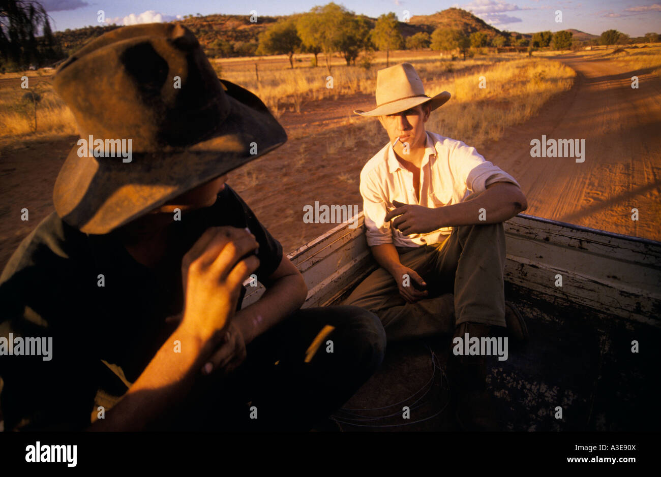 Stockmen ringers riding in back of ute Napperby Station Tanami Region Northern Territory