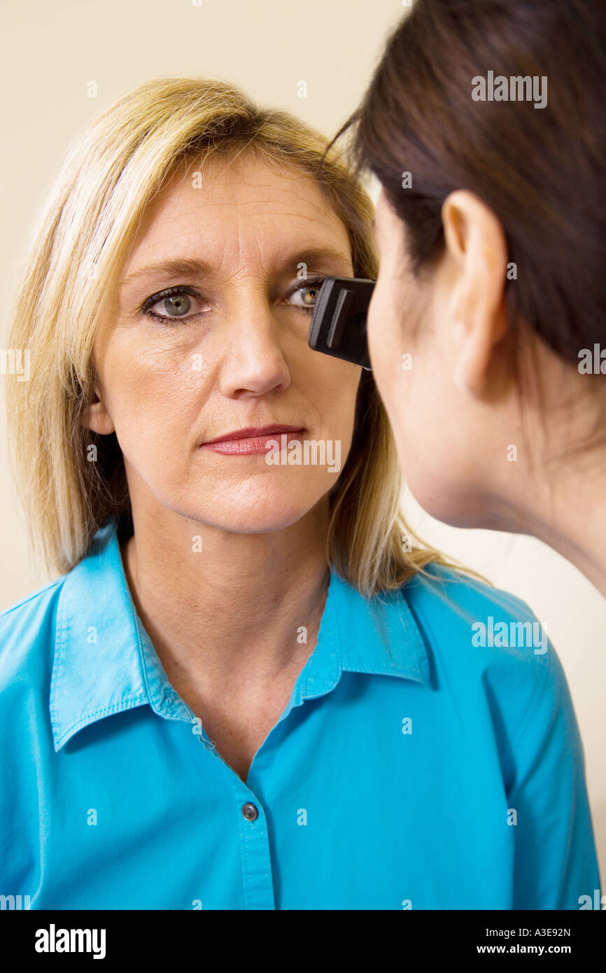 Female patient receives an eye exam from a female doctor Stock Photo