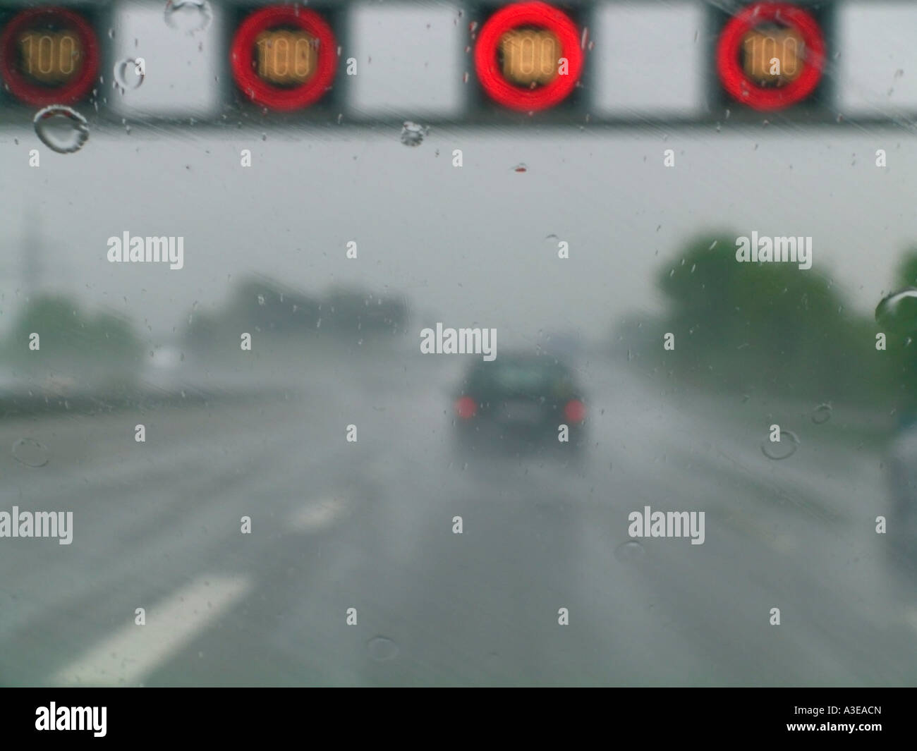 Electric signs for speed limit above a moroway in rainy weather Stock Photo