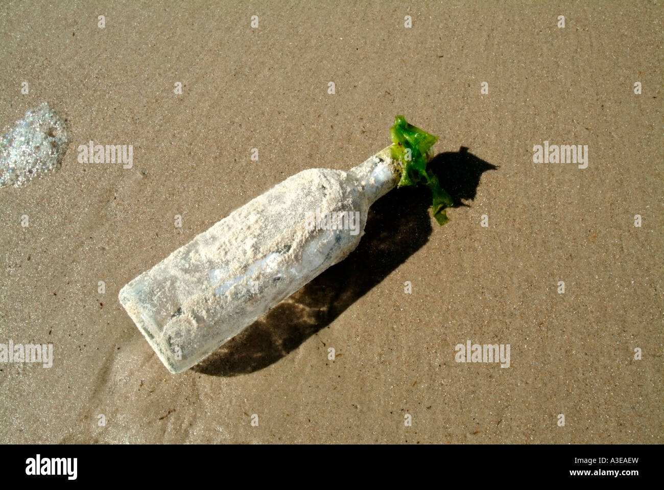 Bottle post bottle washed up on a beach Stock Photo - Alamy
