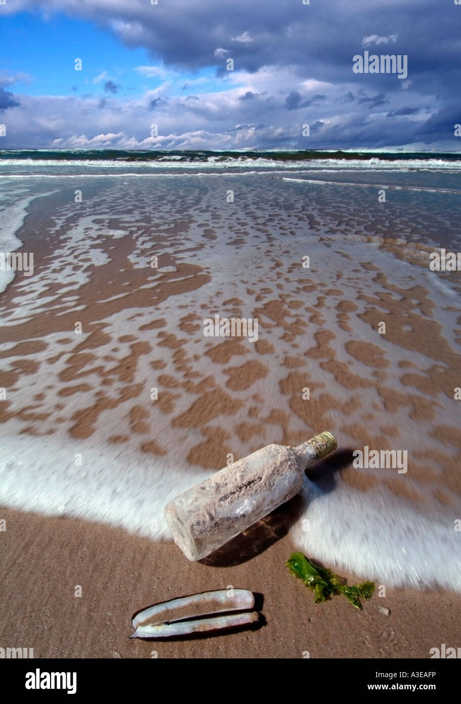 Bottle post bottle washed up on a beach Stock Photo - Alamy