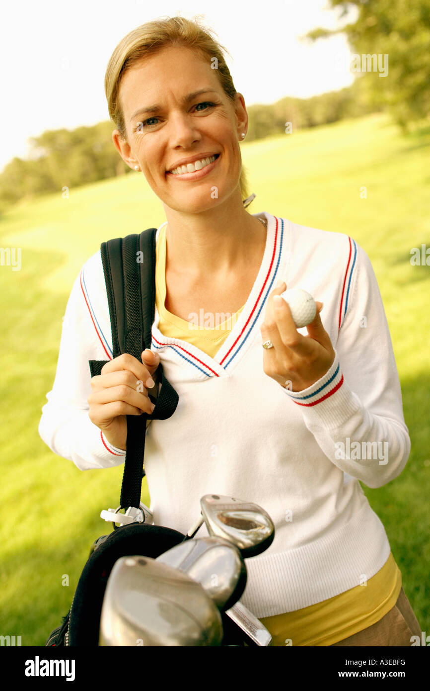 Portrait of a mid adult woman carrying a golf bag Stock Photo Alamy