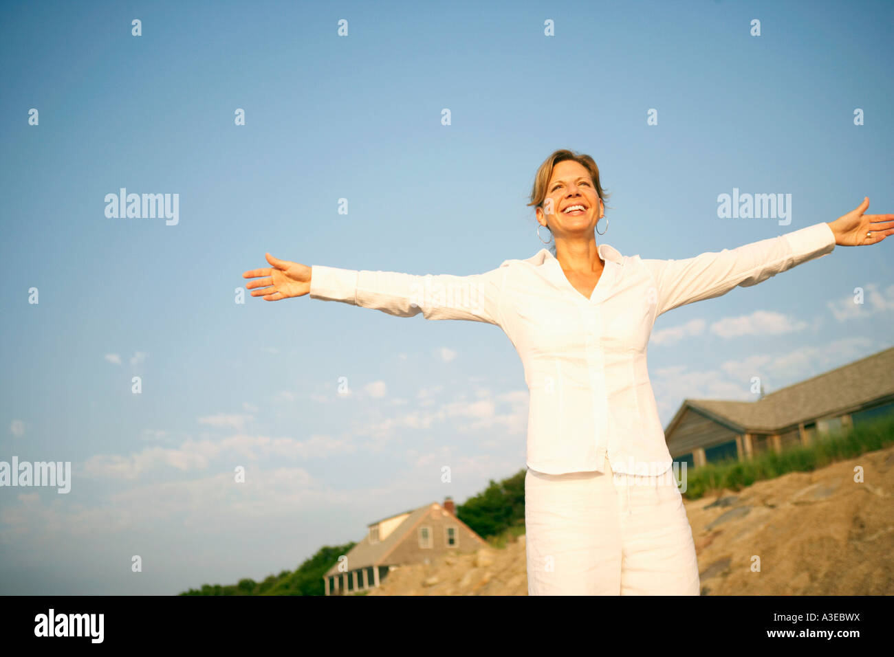 Mature woman smiling with her arms outstretched Stock Photo - Alamy