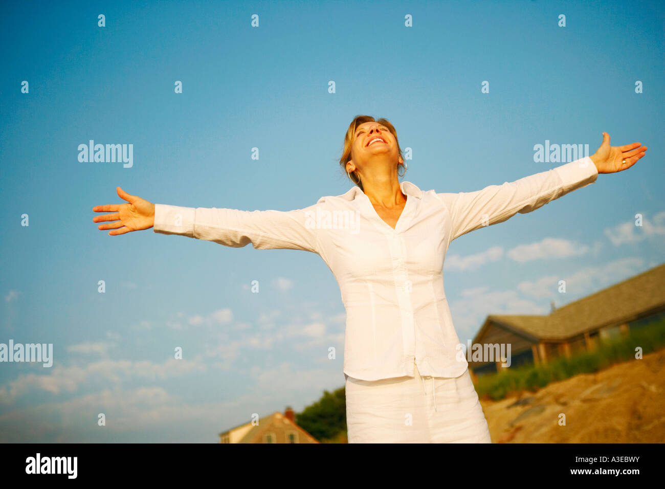 Mature woman smiling with her arms outstretched Stock Photo - Alamy