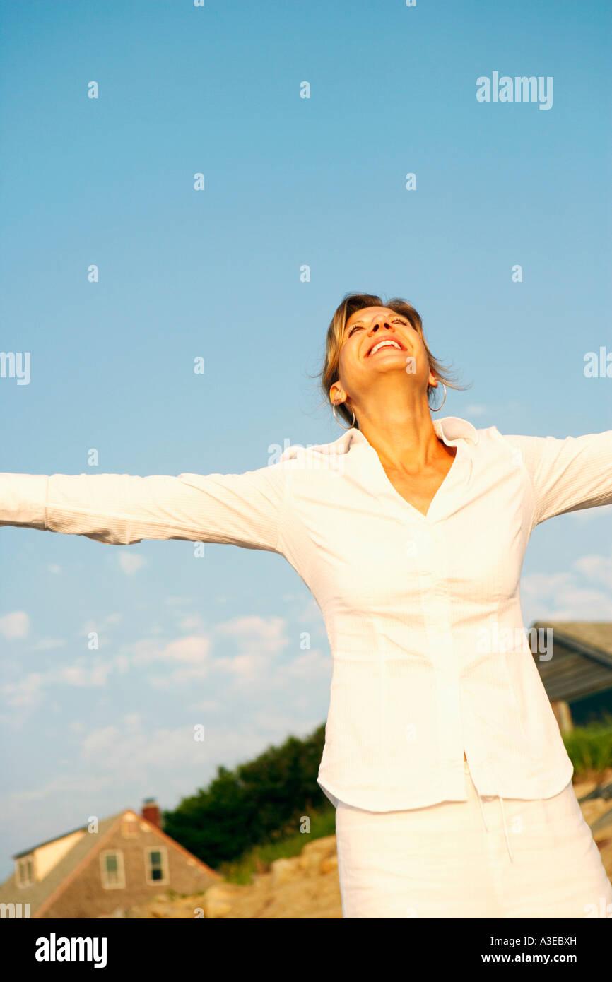 Mature woman smiling with her arms outstretched Stock Photo