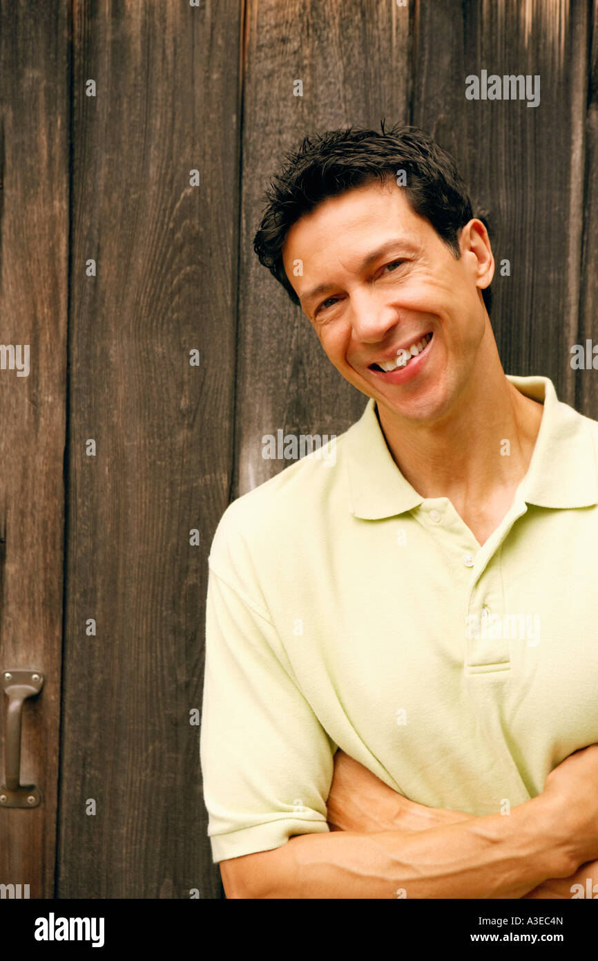 Portrait of a mature man with his arms crossed smiling Stock Photo - Alamy