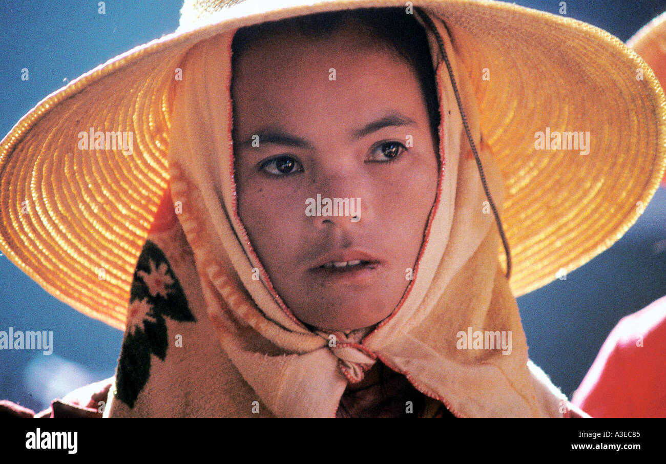 A young woman wears a straw hat in the street market in Ching Hong in the Chinese province of Yunnan Purcell Team Stock Photo