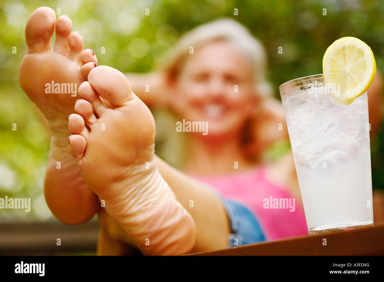 Mature female feet Close Up Of A Mature Woman S Foot With A Glass Of Lemon Juice Beside Her Stock Photo Alamy