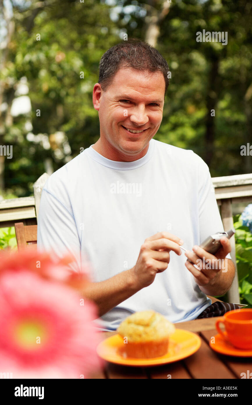 Portrait of a mature man holding a palmtop Stock Photo