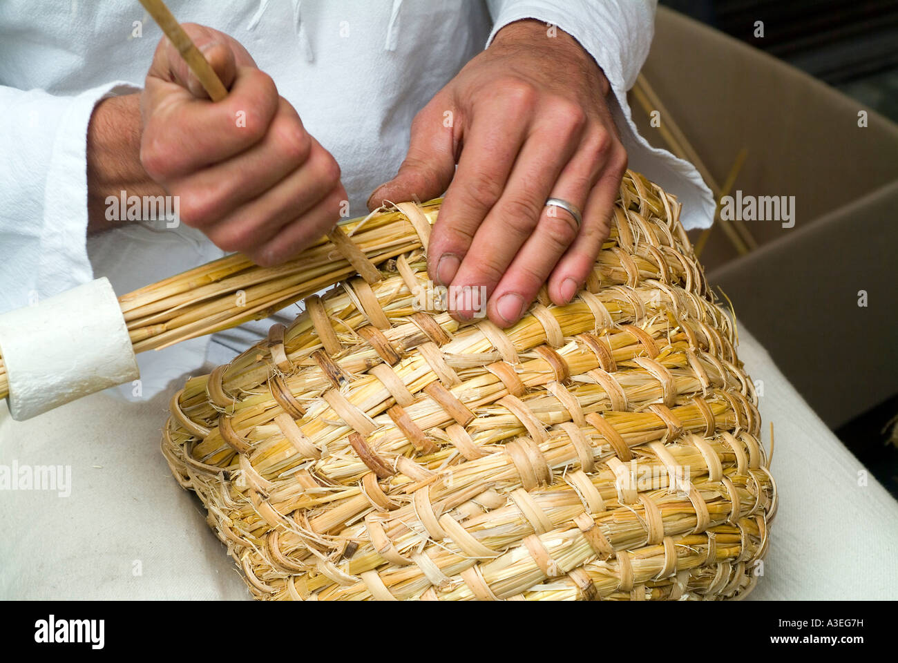 A Beekeeper weaves a beehive Stock Photo