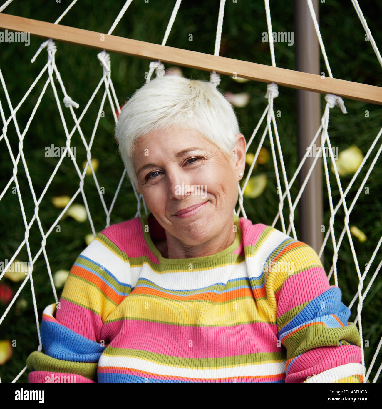 Portrait of a mature woman lying in a hammock Stock Photo - Alamy