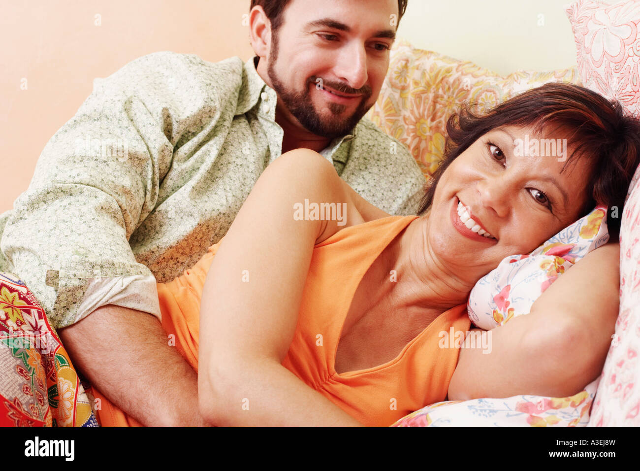 Portrait of a mature man embracing mature woman from behind Stock Photo ...