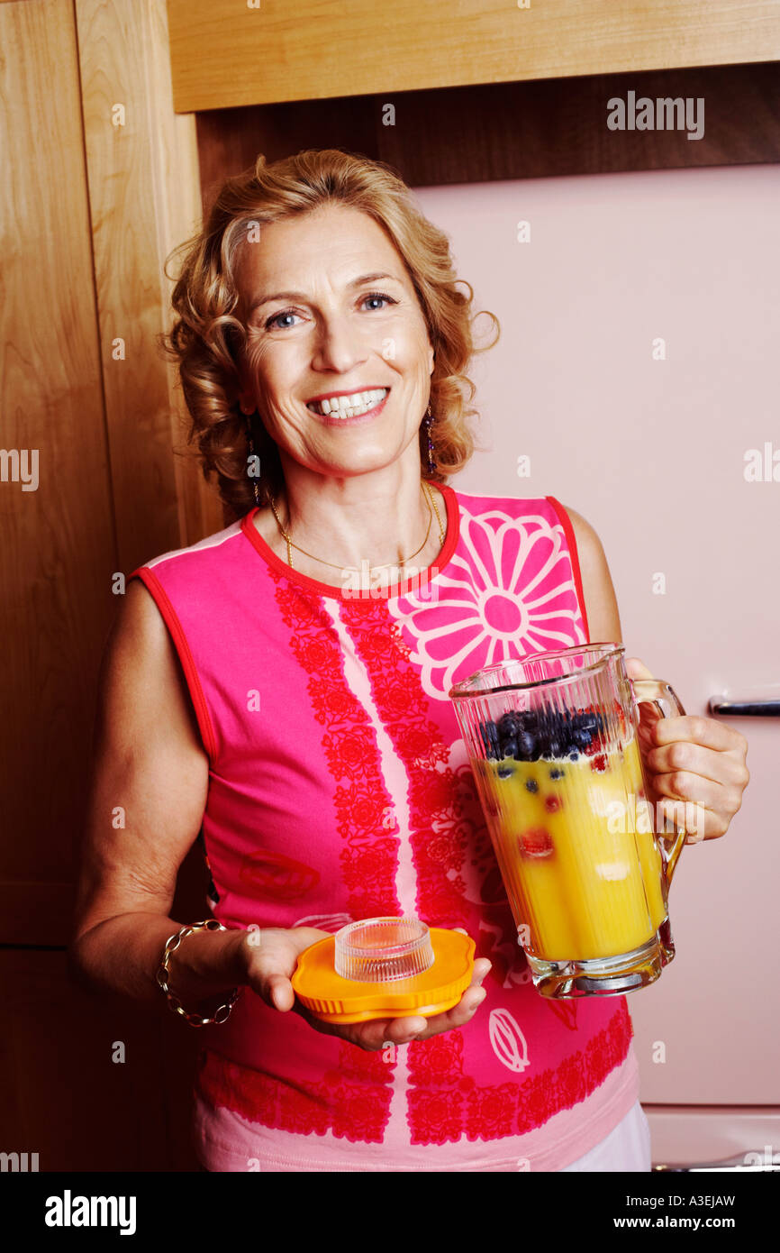 Portrait of a mature woman holding a jug of mango shake Stock Photo