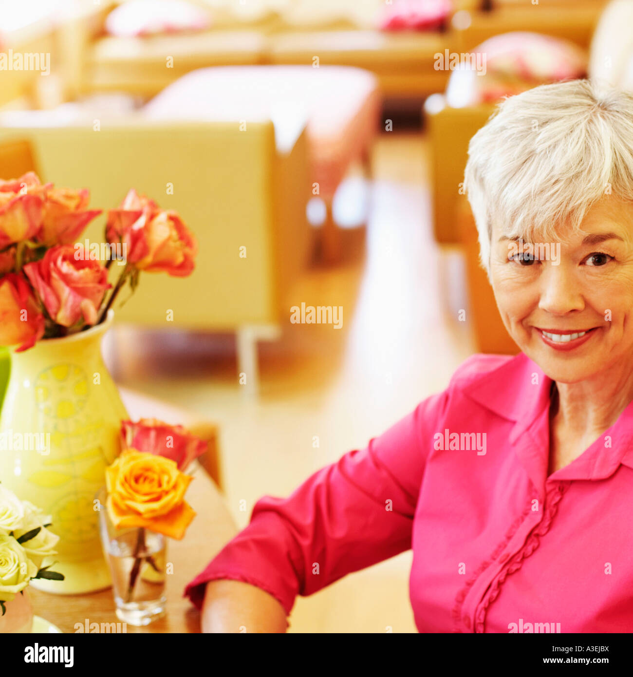 Portrait of a senior woman sitting and smiling Stock Photo - Alamy