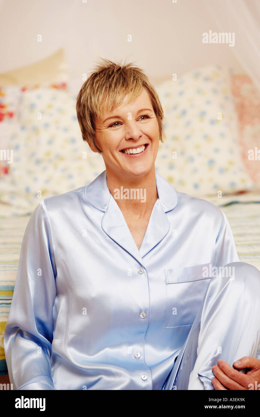 Mature woman sitting and smiling Stock Photo - Alamy