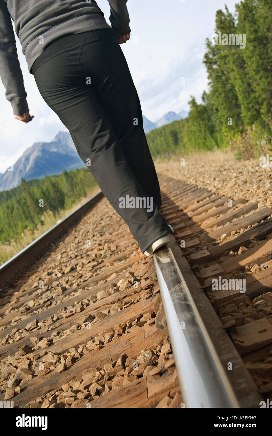 Woman walking on train tracks Stock Photo Alamy