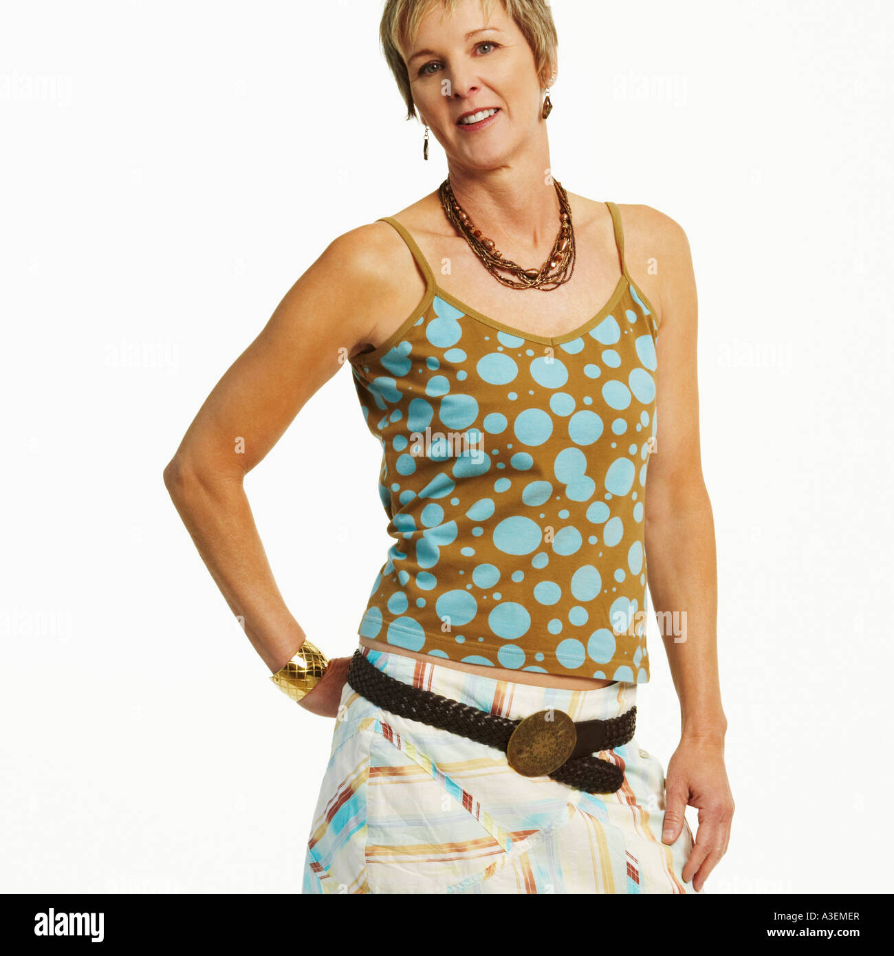 Portrait of a mature woman standing with her hand behind her back Stock ...