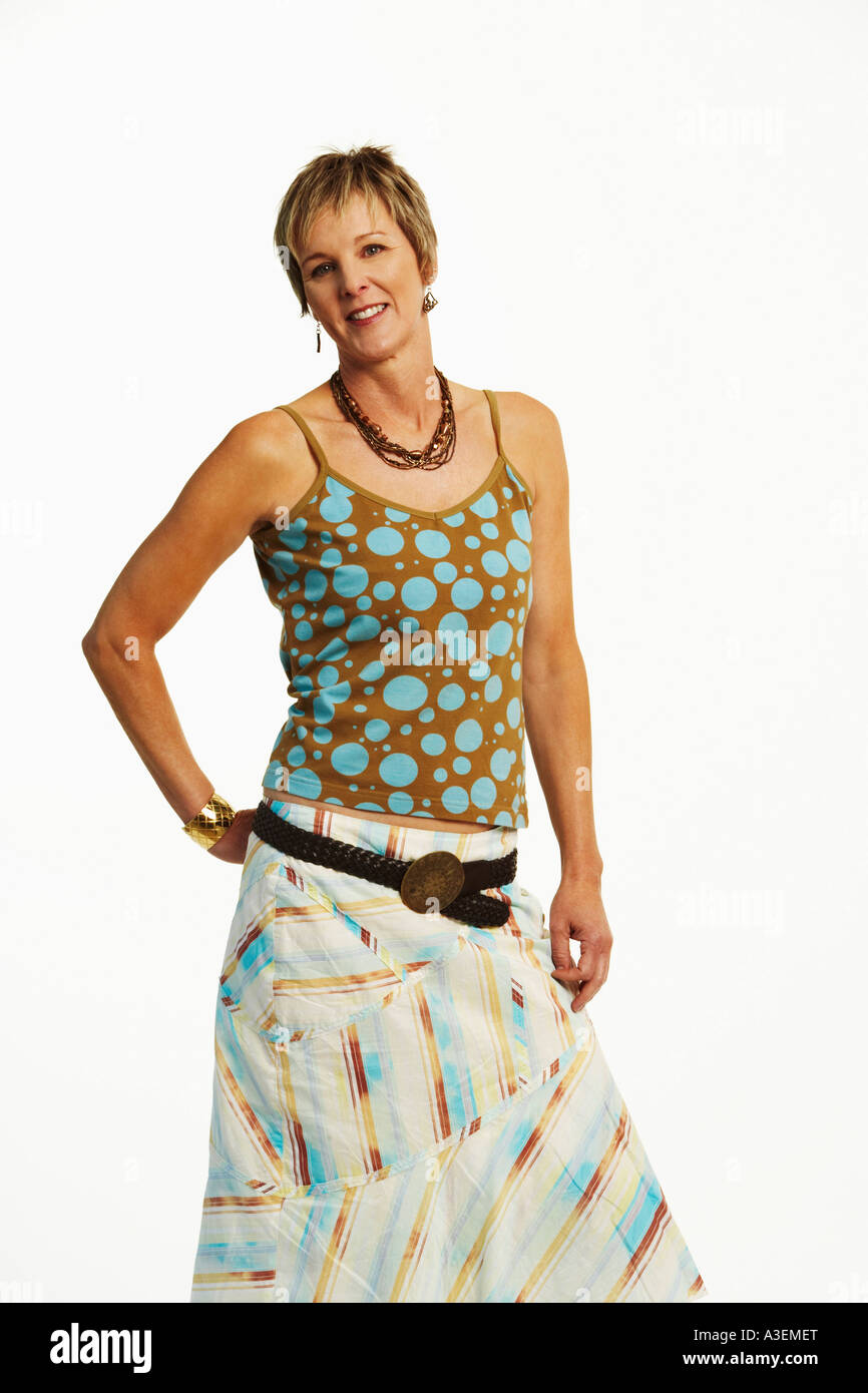 Portrait of a mature woman standing with her hand behind her back Stock ...