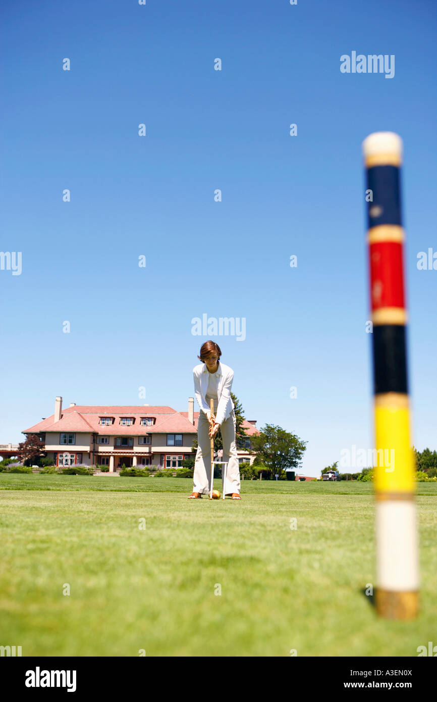 Mid adult woman playing croquet in a playing field Stock Photo Alamy