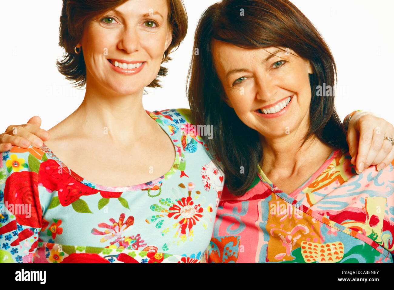 Portrait of a mid adult woman and a mature woman with their arm around ...