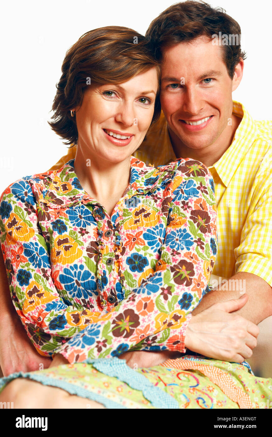 Portrait of a mid adult man embracing a mid adult woman and smiling ...