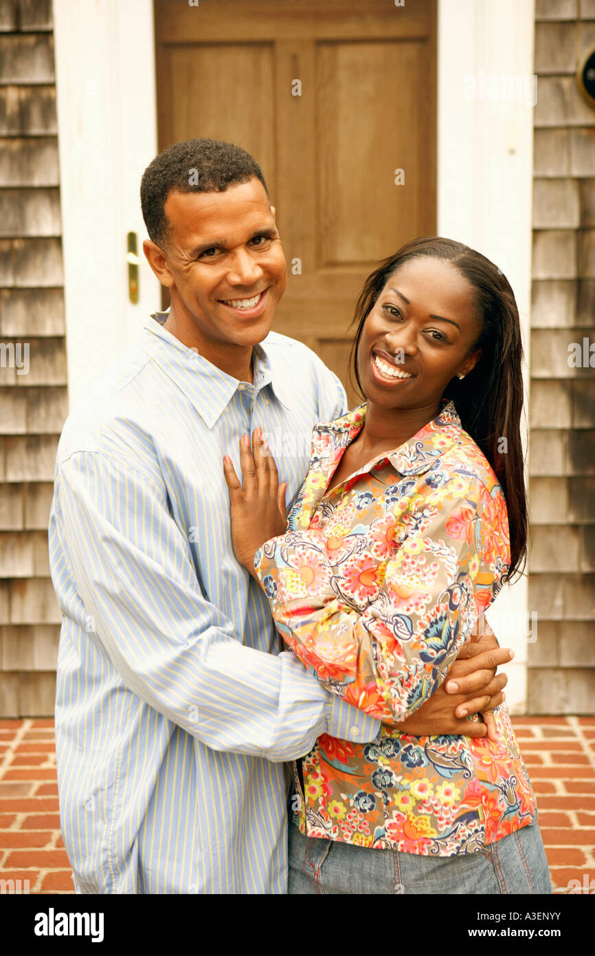 Portrait of a mature man embracing a mid adult woman and smiling Stock ...