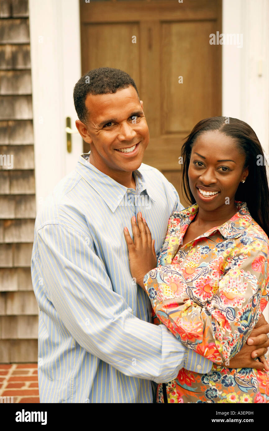 Portrait of a mature man embracing a mid adult woman Stock Photo - Alamy