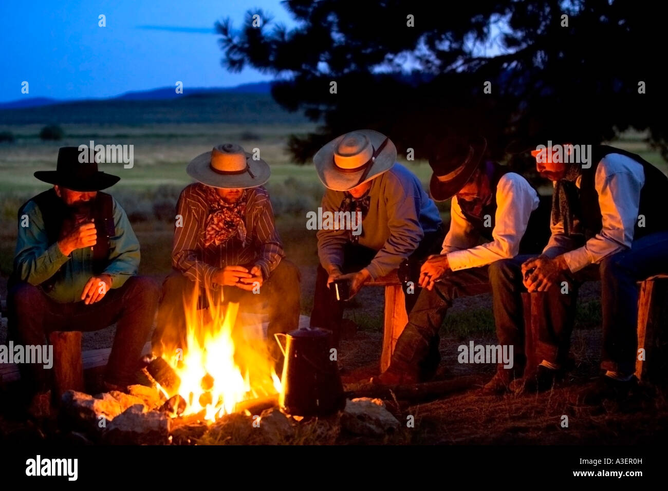 Group of cowboys around a campfire Stock Photo