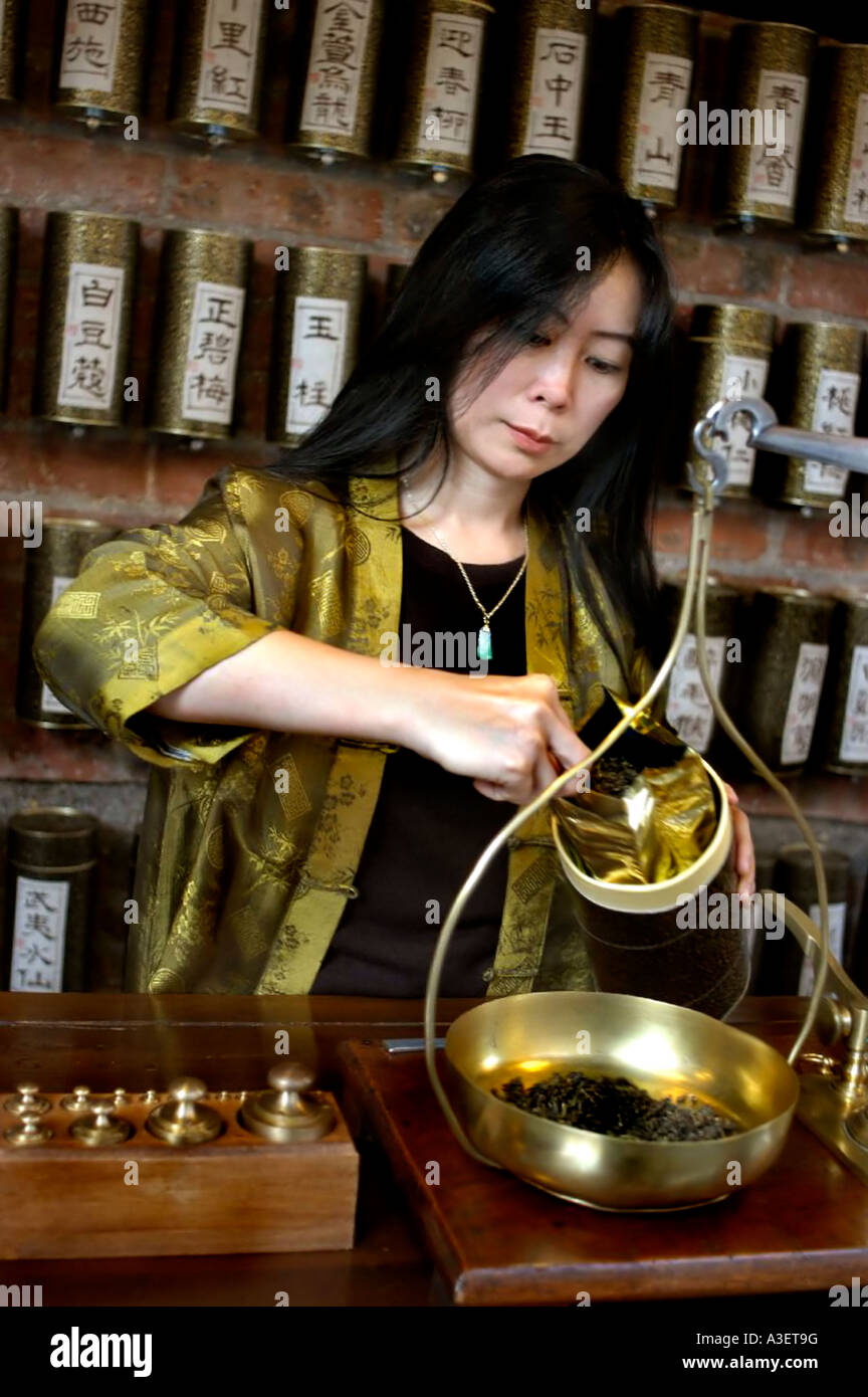 PARIS FRANCE, Chinese Tea Specialist "Yu Hui Tseng" weighing black tea on scale in tea room