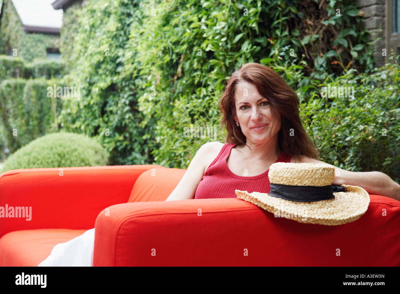 Portrait of a mature woman sitting in an armchair Stock Photo - Alamy