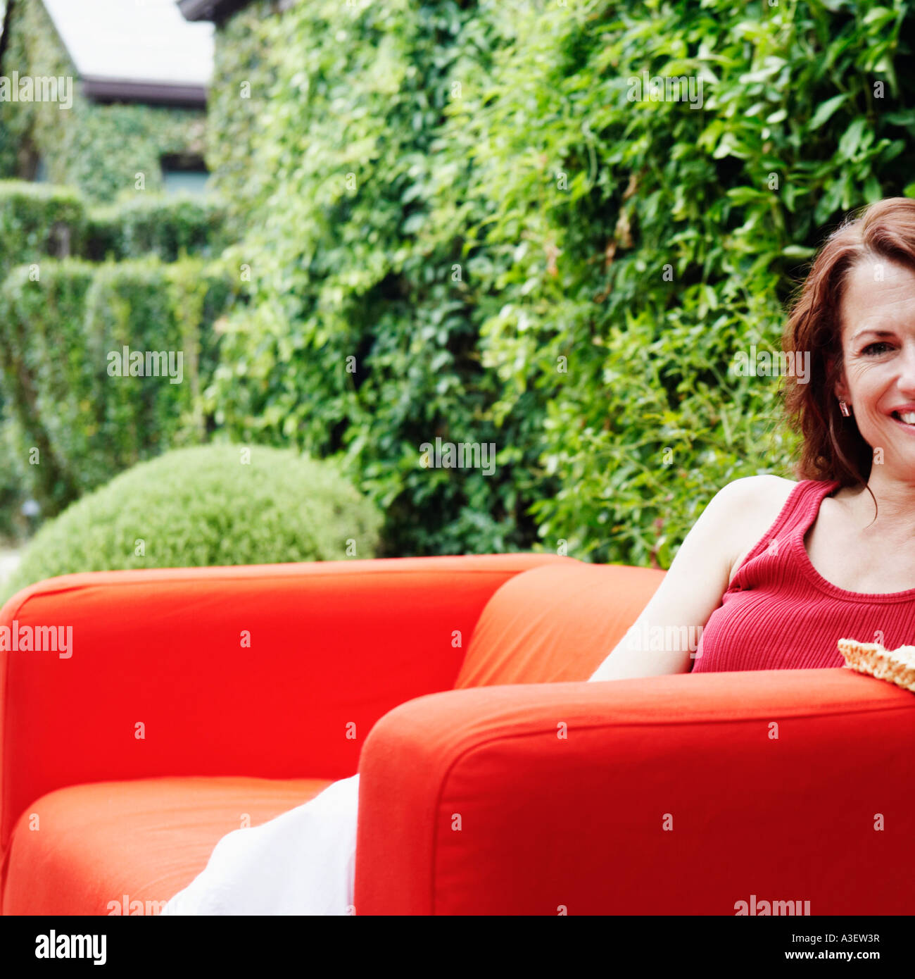 Portrait of a mature woman sitting in an armchair Stock Photo - Alamy