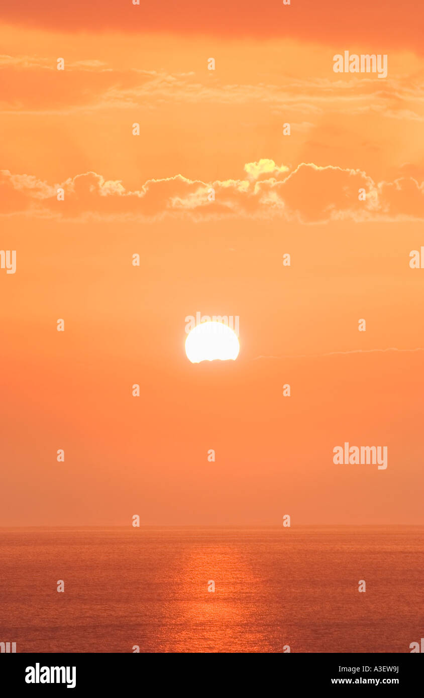 Sunset over water Stock Photo - Alamy