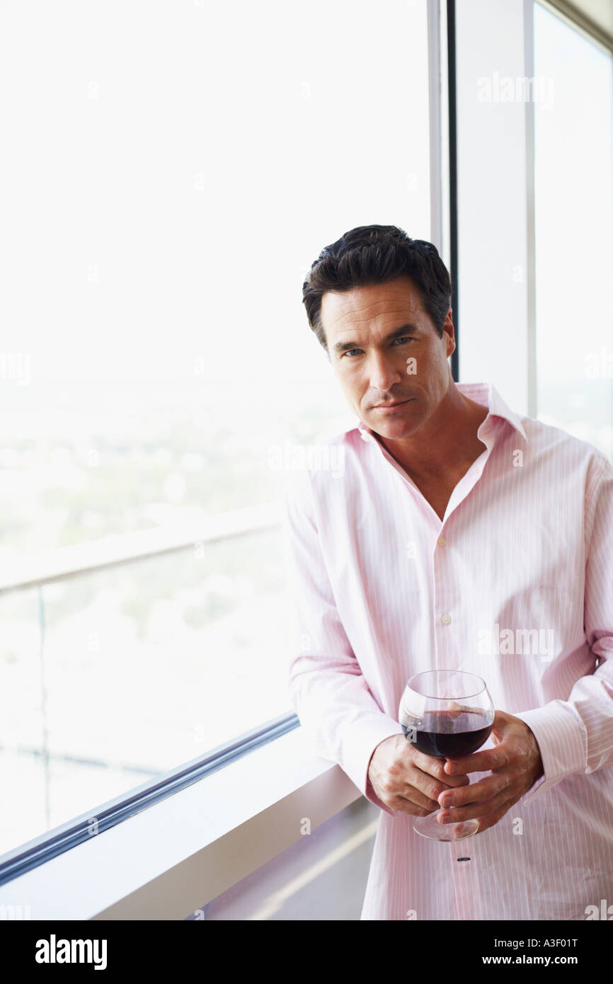 Portrait of a mature man holding a glass of wine Stock Photo
