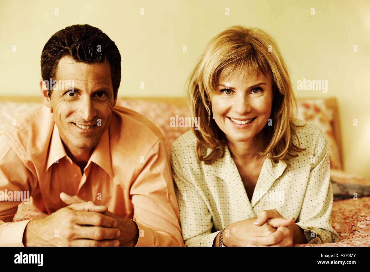 Portrait of a mature couple lying on the bed and smiling Stock Photo ...