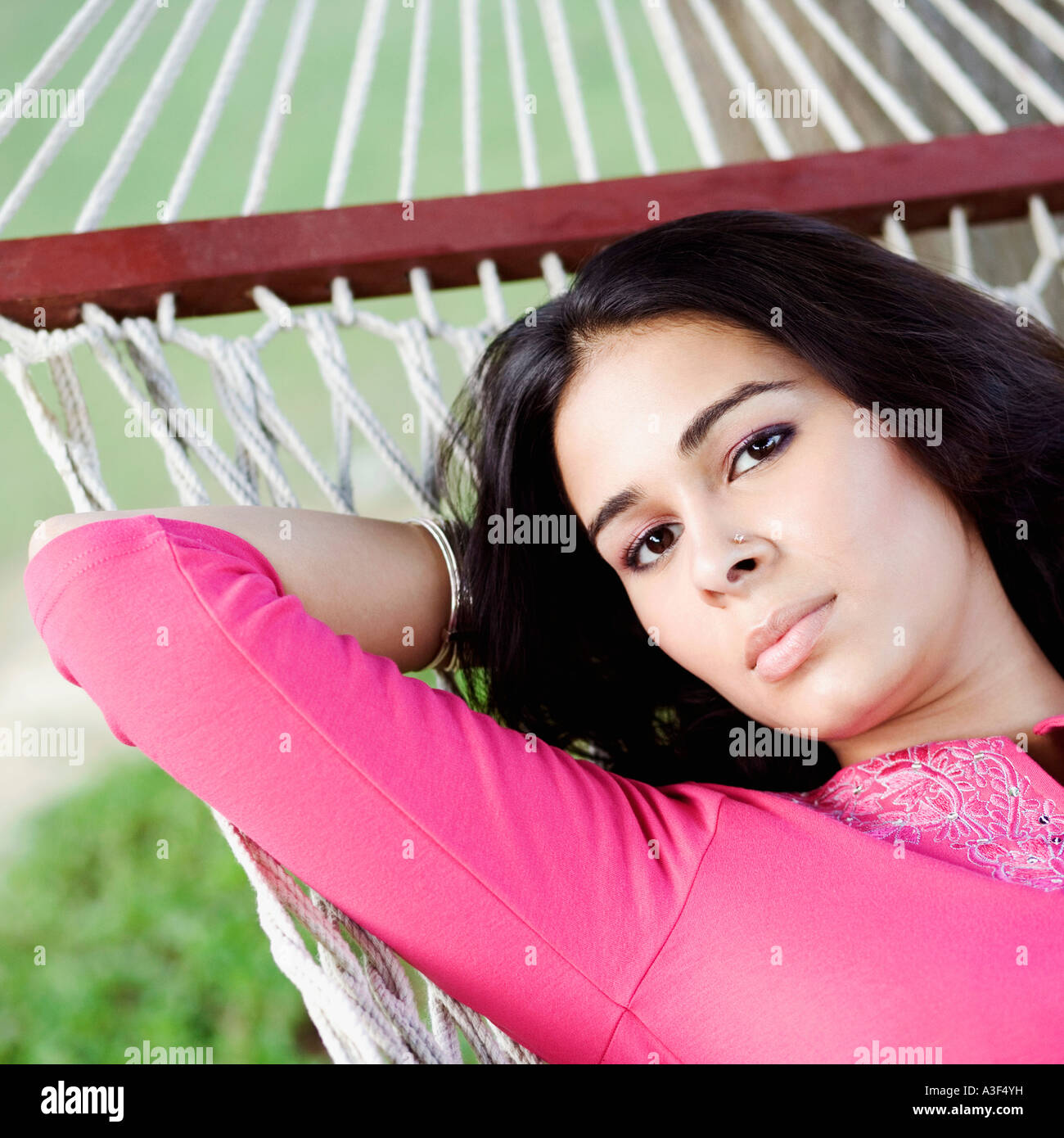 Portrait of a young woman lying in a hammock Stock Photo - Alamy